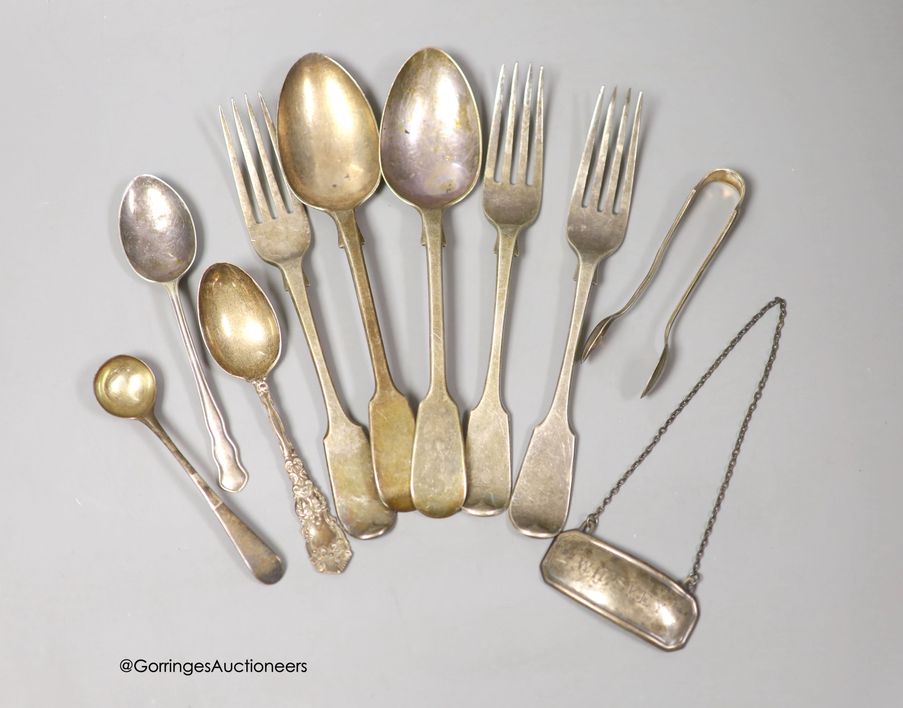 Nine items of assorted 19th century and later silver flatware and a silver 'Whiskey' wine label, 9.5oz.